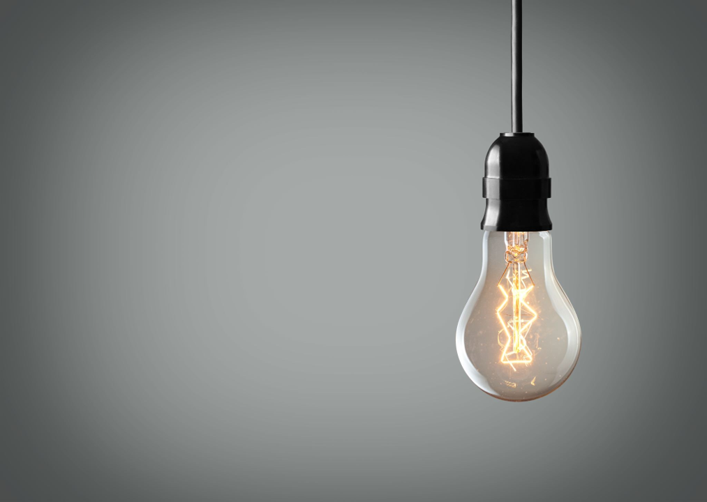 Glowing light bulb symbolizing clarity and innovative business outcomes from technology.